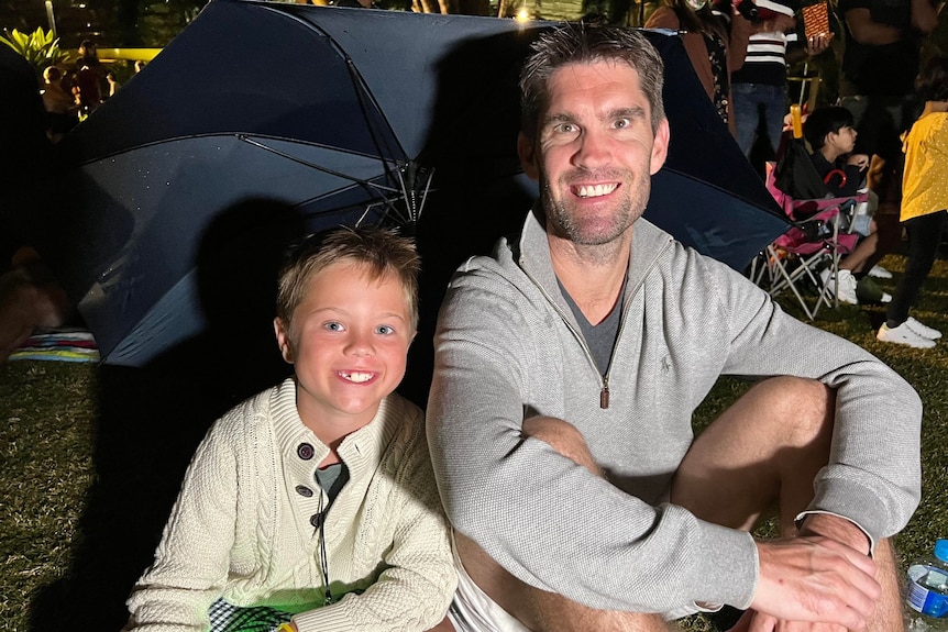 Stewart Wilton with his stepson Hugh sitting on the grass.