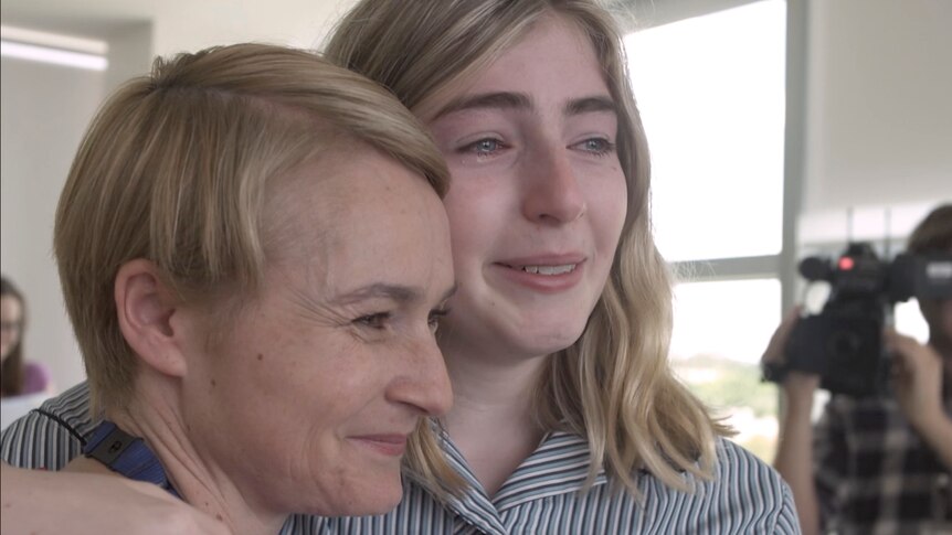 Close up of Georgie Stone hugging her mother Rebekah Robertson smiling with tears in their eyes