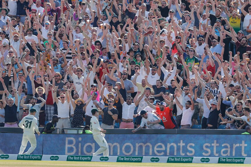The Western Terrace celebrates a six in front of two Australian players