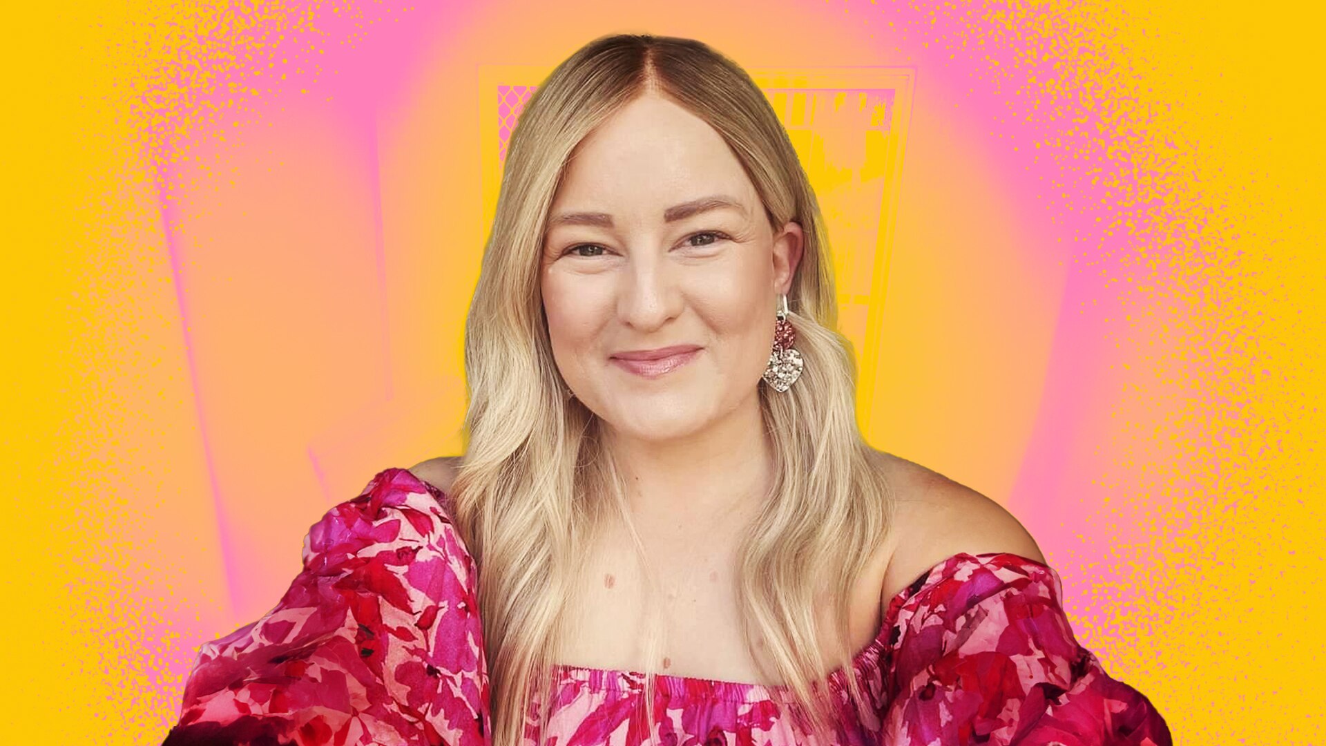 Tash smiling in a selfie, wearing an off-the-shoulder long sleeve pink dress with floral print.