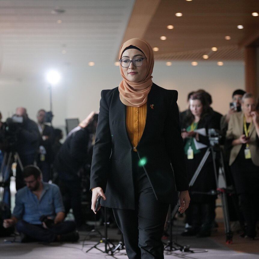 Fatima Payman walks away from a press conference at parliament house