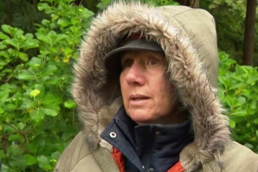 A woman wearing a hooded jacked.