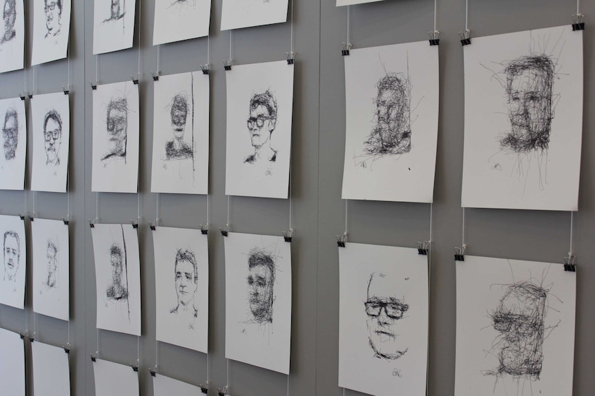 Wall of portraits in pen and pencil