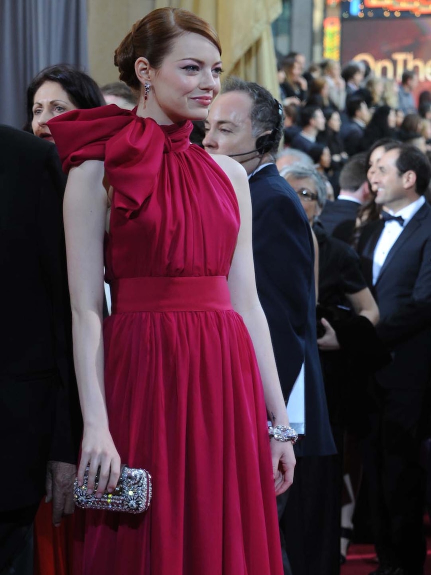 Emma Stone arrives on the red carpet for the 84th annual Academy Awards