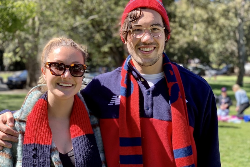 A man and woman smile at the camera 