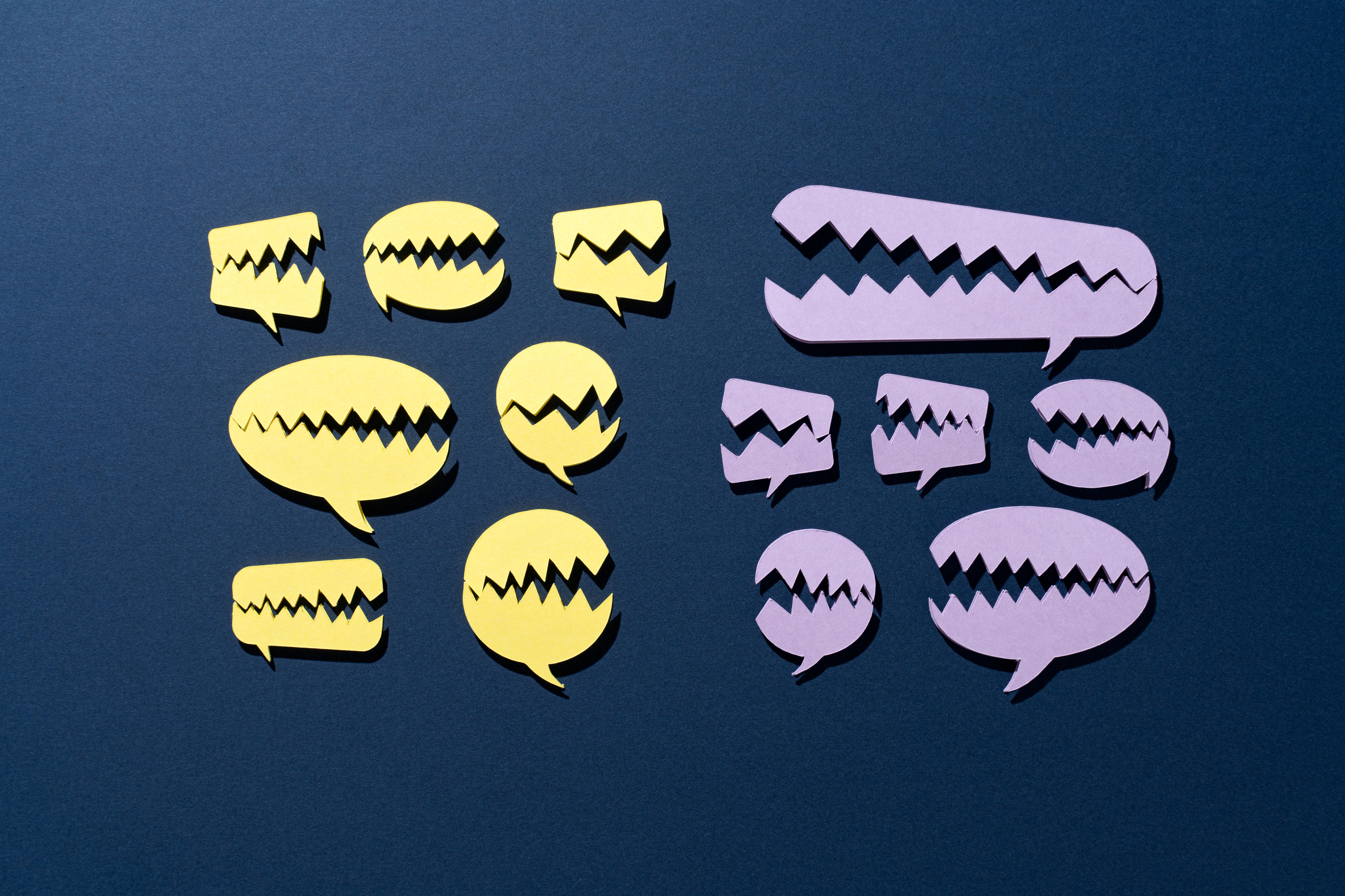 Illustration of cartoon speech bubbles with dinosaur like teeth.