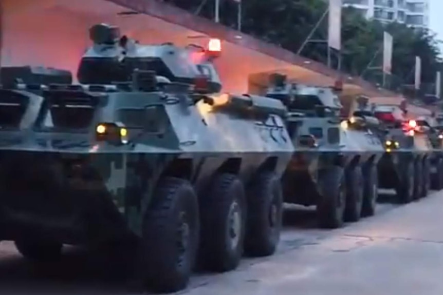 Chinese troops enter Shenzhen in armoured vehicles.