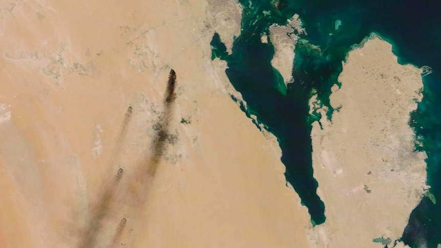 A satellite photo of dark plumes of smoke stretching across the north-eastern Saudi Arabian countryside.