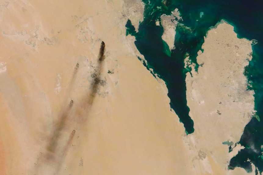 A satellite photo of dark plumes of smoke stretching across the north-eastern Saudi Arabian countryside.