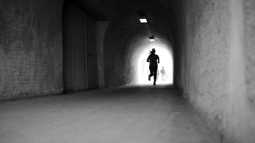 A runner through a tunnel.