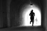 A runner through a tunnel.