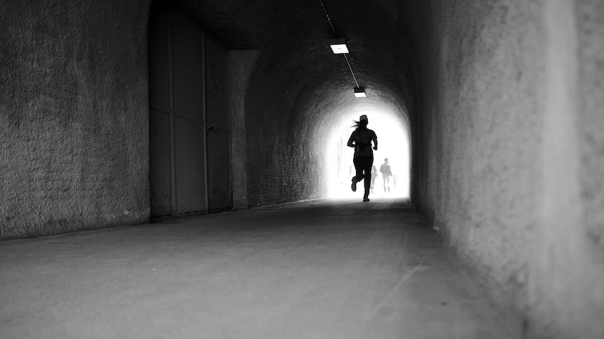 A runner through a tunnel.