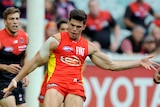 Gold Coast's Jaeger O'Meara clears the ball against Melbourne at the MCG in April 2014.