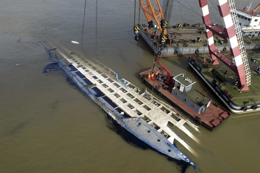 Rescuers work on righting the capsized cruise ship Eastern Star