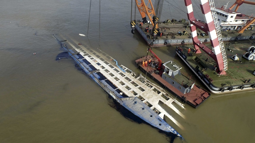 Rescuers work on righting the capsized cruise ship Eastern Star