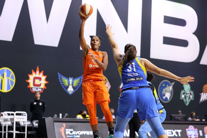 Connecticut Sun player Alyssa Thomas (left) shoots a hook shot against the Chicago Sky.