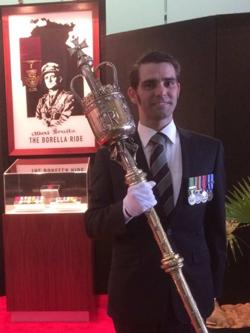 Ben Harris stands in front of a display of Albert Borella's Victoria Cross