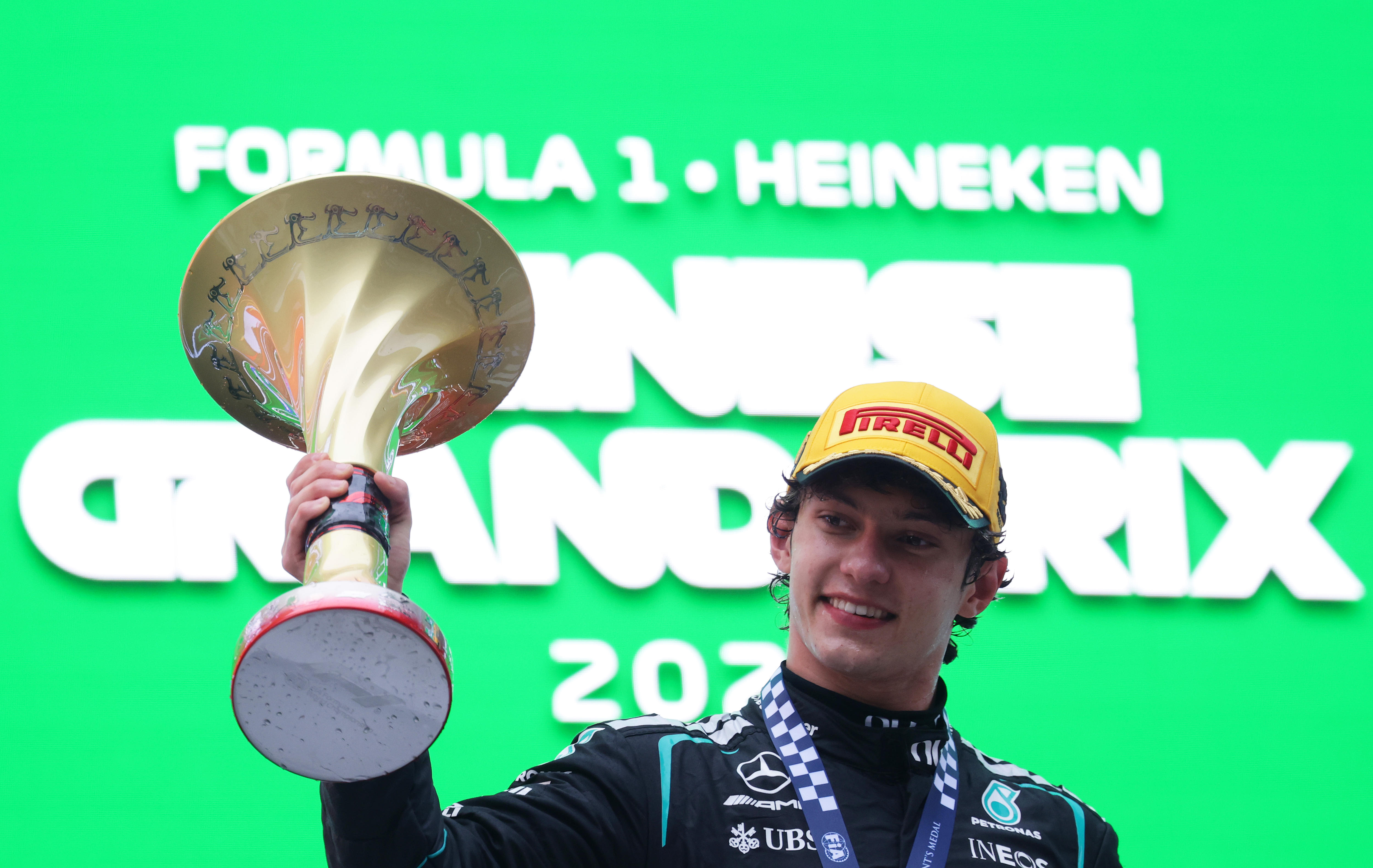 Race winner Andrea Kimi Antonelli of Italy and Mercedes holding the trophy on the podium, smiling