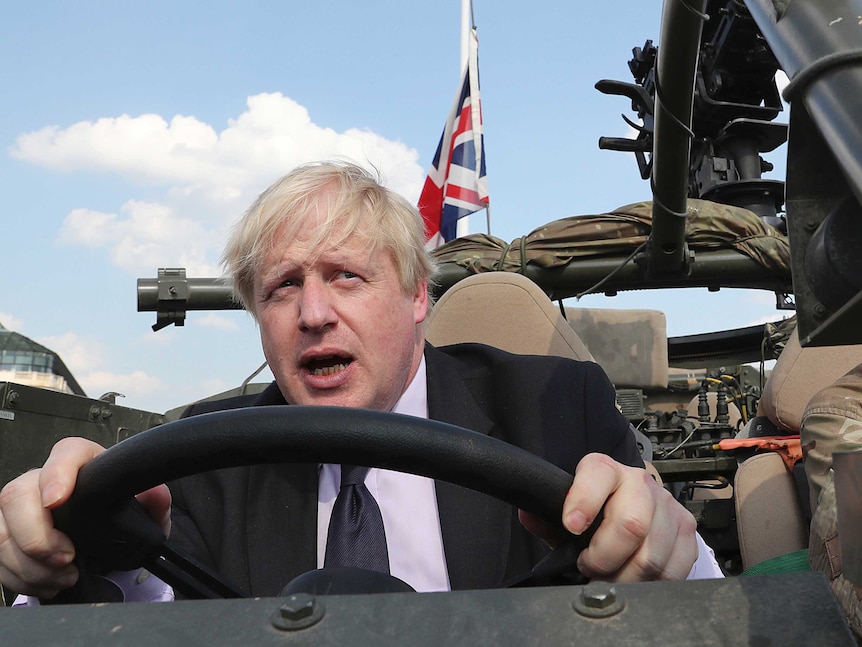 Britain's Foreign Secretary Boris Johnson talks during a ceremony at the Tomb of the Unknown Soldier in Warsaw, Poland