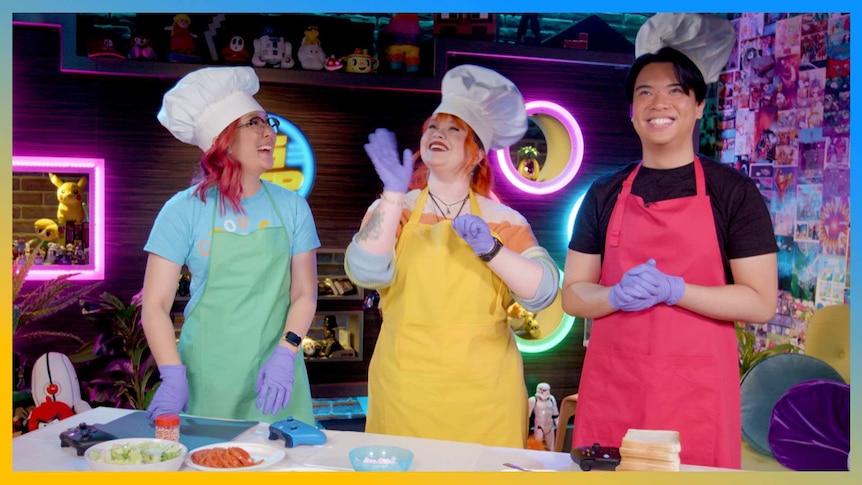 Rad, Gem and Jax wearing colourful aprons and chefs hats