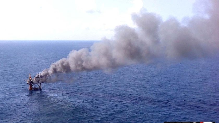 Smoke pours from an offshore oil platform in the Gulf of Mexico