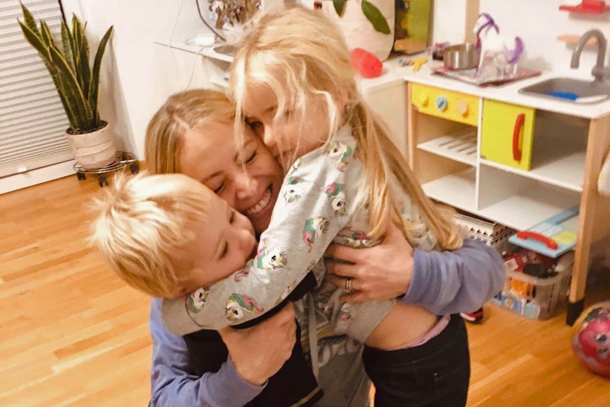 Bettina Rowley hugs her two young children Charlotte and Freddie.