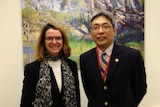 Cai Wei and Anne Ruston in an office.