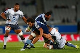 Steven Luatua of the Blues is tackled by the Western Force in their round 12 Super Rugby game.