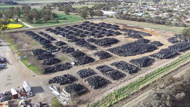 Aerial view shows millions of tires in dirt paddock
