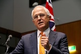 Prime Minister Malcolm Turnbul at a podium announces a July 2 election at Parliament House.