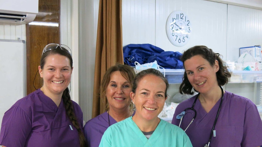 Some of the members of the medical team in Mosul wearing scrubs and smiling for photo