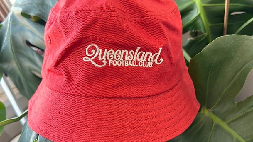 red bucket hat with Queensland Football Club label