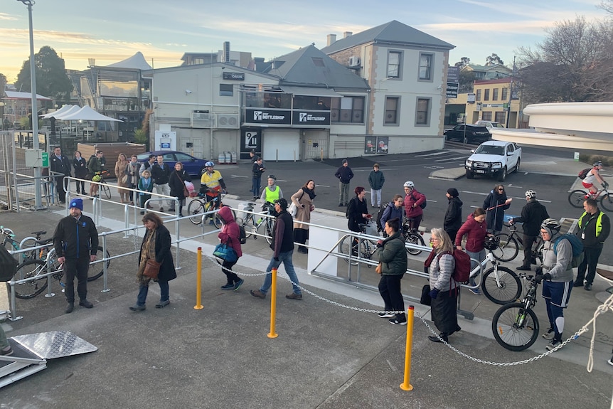 Commuters queue for ferry service.