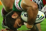 Greg Inglis is lifted by the Manly defence