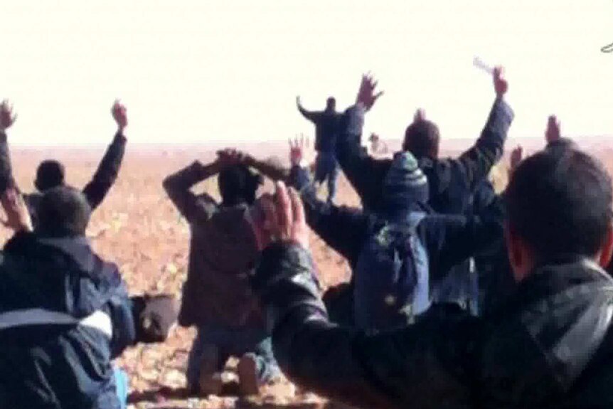Algeria's Ennahar TV shows hostages surrendering to Islamist gunmen who overtook a remote gas facility.