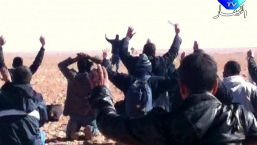 Hostages surrendering to Islamist gunmen who overtook a remote gas facility. (AFP/Ennahar TV)