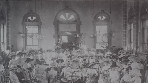 An old photo of inside a party at a town hall