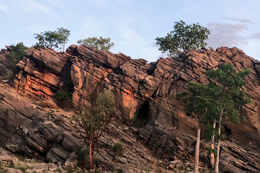 Red cliffs in the outback against blue sky