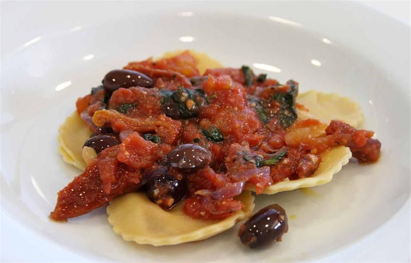 Homemade pumpkin ravioli with semi dried tomatoes, kalamata olives and ...