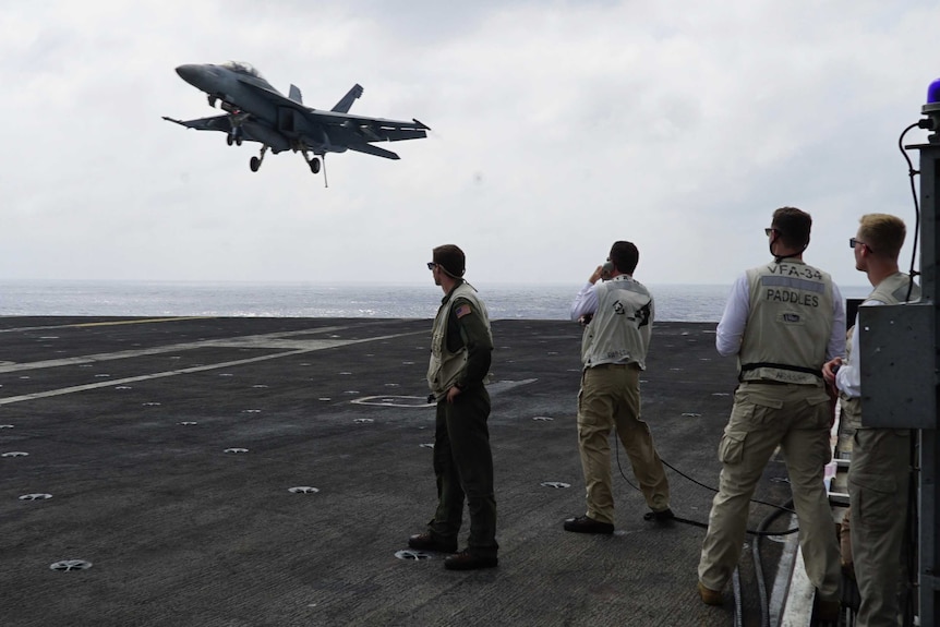 A fighter jet lands on US aircraft carrier Carl Vinson in the South China Sea.