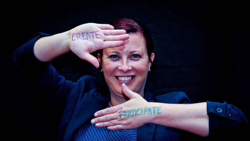 Image of Jaelea Skehan with 'create' and 'participate' written on her hands