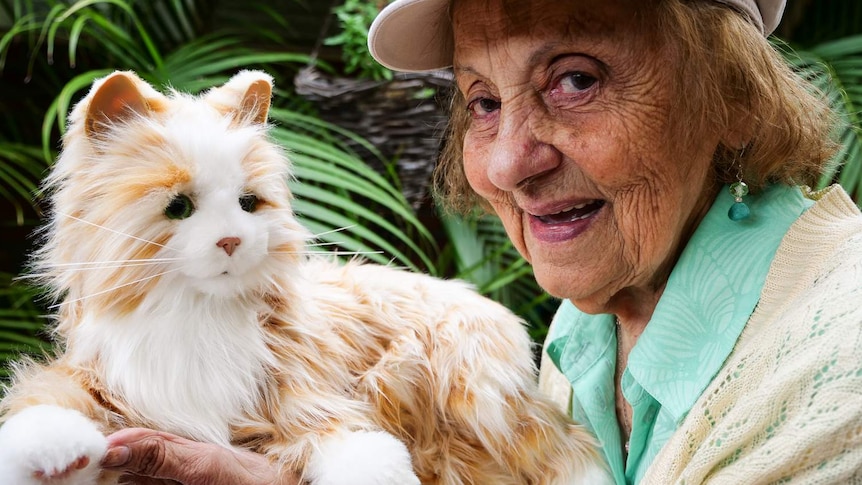 Close up of aged care resident  with a robotic cat