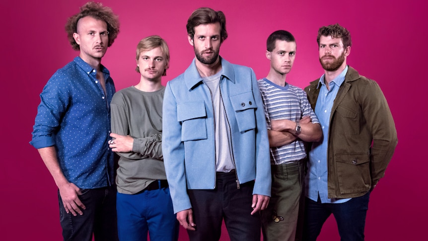 A 2017 press shot of The Rubens against a pink background
