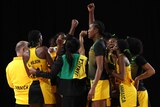 Jamaica's netball team gather in a huddle to celebrate beating Australia.