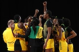 Jamaica's netball team gather in a huddle to celebrate beating Australia.