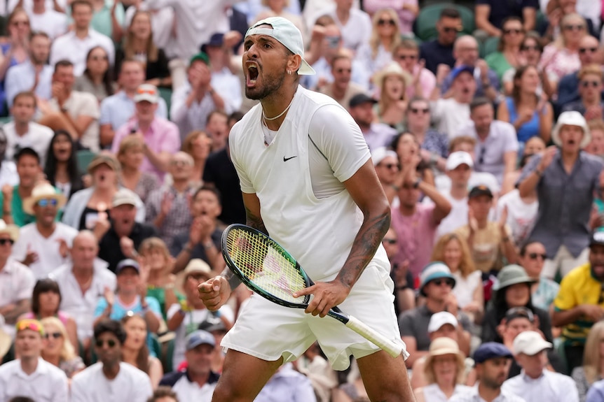 Nick Kyrgios yells in delight while the crowd cheers behind him