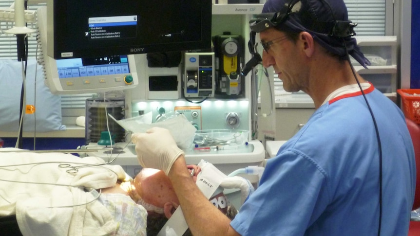 Surgeon Dr Roger Grigg prepares Trevor Bennett for the robotic assisted surgery