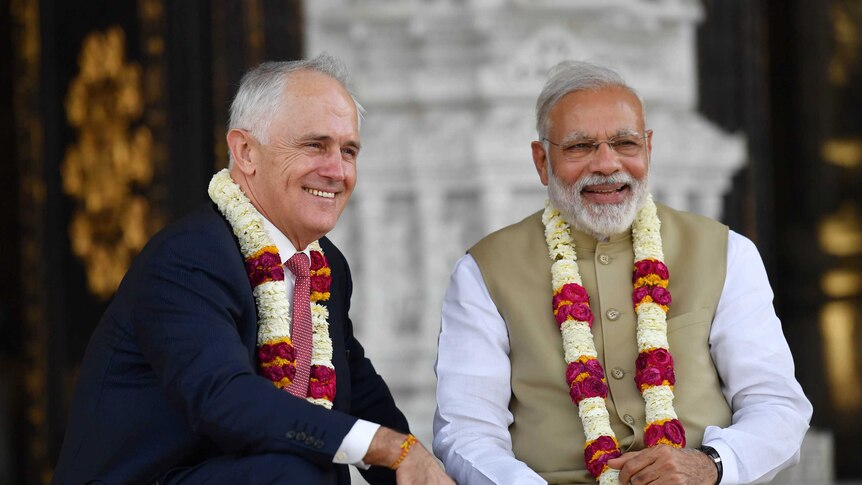 Malcolm Turnbull and Narendra Modi wear flowers while visitng Akdhardham Madir hindu temple in New Dehli