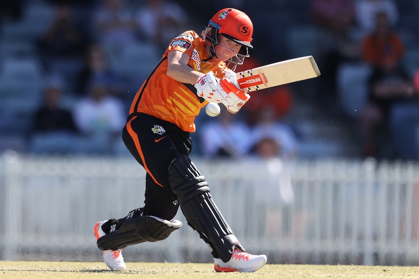 A Perth Scorchers WBBL player hits the ball to the leg side against Melbourne Renegades.