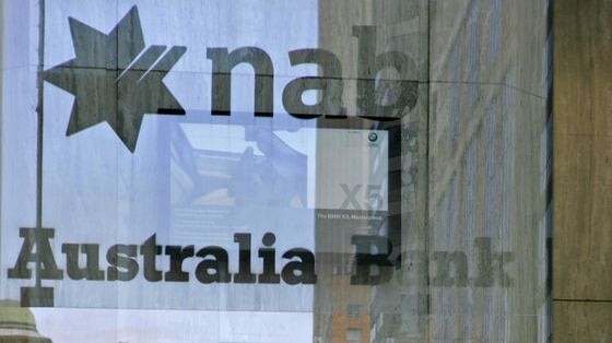 Businessmen are seen through the window in the NAB office